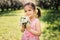 Spring closeup outdoor portrait of adorable kid girl