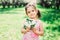 Spring closeup outdoor portrait of adorable kid girl