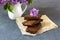 Spring composition with lilac flowers and brownie, wet cake. Dessert for served for tea or coffee break. Snack on a spring day in