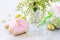 Spring concept. Colorful Easter background with colored eggs and Easter baking on a gray stone background