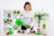 Spring concept - mature woman watering potted plants at home