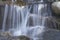 spring of cool and cold water flowing down through rocks, alaska