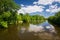 Spring countryside - river and blue sky with clouds