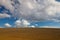 Spring cultivated field in the empty landscape