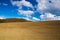 Spring cultivated field in the empty landscape