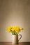 Spring Daffodils in Vintage Enamel Jug on Table