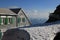 Spring day on Mount Santis. Snow field, old hotel and Churfirsten Range. Travel destination in the Swiss Alps.