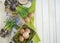 Spring decorative composition. Flowers in a basket and pots of hyacinth, muscari, narcissus. Wooden background.