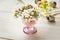 Spring delicate white yellow flowers in crystal egg cup, quail eggs, Easter decoration