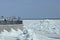 Spring drifting of ice on the Amur River. View of the embankment of the city of Blagoveshchensk, Russia. River port cranes. Large