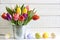 Spring easter tulips in bucket with eggs