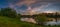 spring evening landscape after a sunset. a panoramic view from the high hilly coast of the river