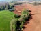 Spring farmland with fields, groves and pond, aerial view