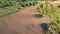 Spring farmland with water puddles and two beehive house on wheels, aerial