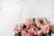 Spring feminine floral web banner, composition. Coral pink peonies flowers on white marble table background. Empty space