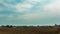 Spring field and tractor, time-lapse