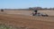 spring field work. the tractor plows the ground. preparation for sowing agricultural crops. farming.