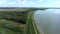 Spring flight above river dam of Kralova, western Slovakia, with side artificial channel visible, nice reflections of clouds