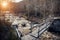 Spring flood. Stormy river rapidly carrying meltwater. Old wooden bridge over mountain stream. Awakening of nature after winter