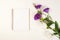 Spring floral mockup with open notebook and eustoma flowers. Flat lay, top view, copy space. Purple and white eustoma flowers on