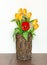 Spring Flower Arrangement with Yellow Tulips and a Single Red Tulip.