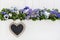 Spring flower background in blue and violet with a sign of heart