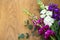 Spring flowers bunch on wooden background. Space for text