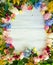 Spring flowers on wood background. Summer blooming border on a w