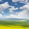 Spring fresh landscape of colorful fields and beautiful hills wi