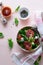 Spring fresh salad with blood orange, lettuce, spinach and sesame seeds on pink background. Top view. Selective focus