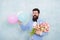 Spring freshness. love date with flowers. spring bouquet. 8 of march. womens day. Formal mature businessman bearded man