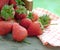 Spring fruits, strawberries in an aluminum bucket on a vintage wooden table