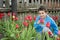 Spring in the garden of a beautiful little boy sitting near tul