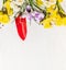 Spring gardening with red hand shovel and flowers: daffodils and crocuses on white wooden background