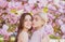 Spring girls. Lesbian couple kissing. Beautiful spring sexy young woman with sakura flowers. Sensual kiss. Lgbt.