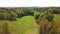 Spring green fields and forest aerial view. Sunny day. View from drone