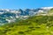 Spring green foliage and snow Mountains by Rila Lakes in Bulgaria