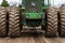 Spring Grove, IL/USA â€“ December, 1 2019: Closeup front view of John Deere tractor in field with muddy tires