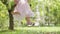 Spring and happy summer time. Closeup of feet of joyful little girl swinging on the swing, child plays in the green sunny garden