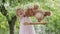 Spring and happy summer time. Joyful smiling little girl playing with teddy bear swinging on the swing, child with blue eyes and