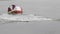 Spring high water, ice floes floating on the river near the buoy with seagulls