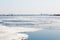 The spring ice drift on the river Volga. Road bridge in the city of Saratov. Russia. A Sunny day in March. Blue sky