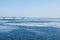 The spring ice drift on the river Volga. Road bridge in the city of Saratov. Russia. A Sunny day in March. Blue sky