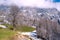 Spring landscape in the Alps with fresh green mountain pastures and snow-capped mountain tops in the background