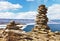 Spring landscape of Baikal Lake with big cairns on a rocky promontory