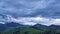 Spring landscape with cumulative clouds, A huge storm cloud forms over the mountains at dusk.