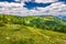 Spring landscape with flowery meadows and mountains.