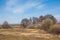 Spring landscape. Freshly plowed field. hilly terrain. trees wit