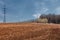 Spring landscape. Freshly plowed field. hilly terrain. trees wit