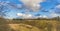 Spring landscape of grassy mound and cloudy sky